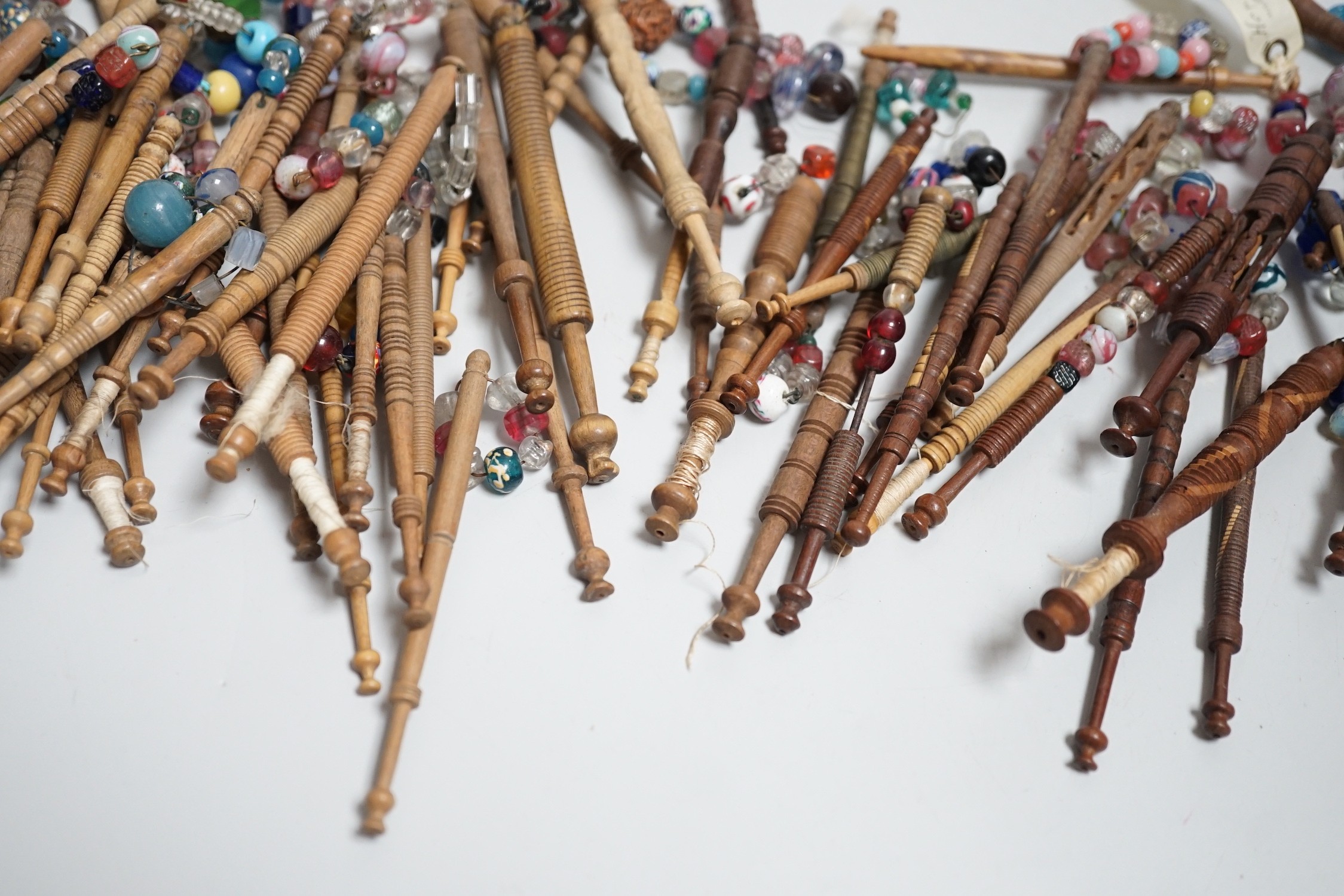 Fifty 19th century finely turned wooden lace bobbins with beaded ends together with 35 ornate wooden bobbins with beaded ends and 5 plain wooden bobbins unleaded (90)